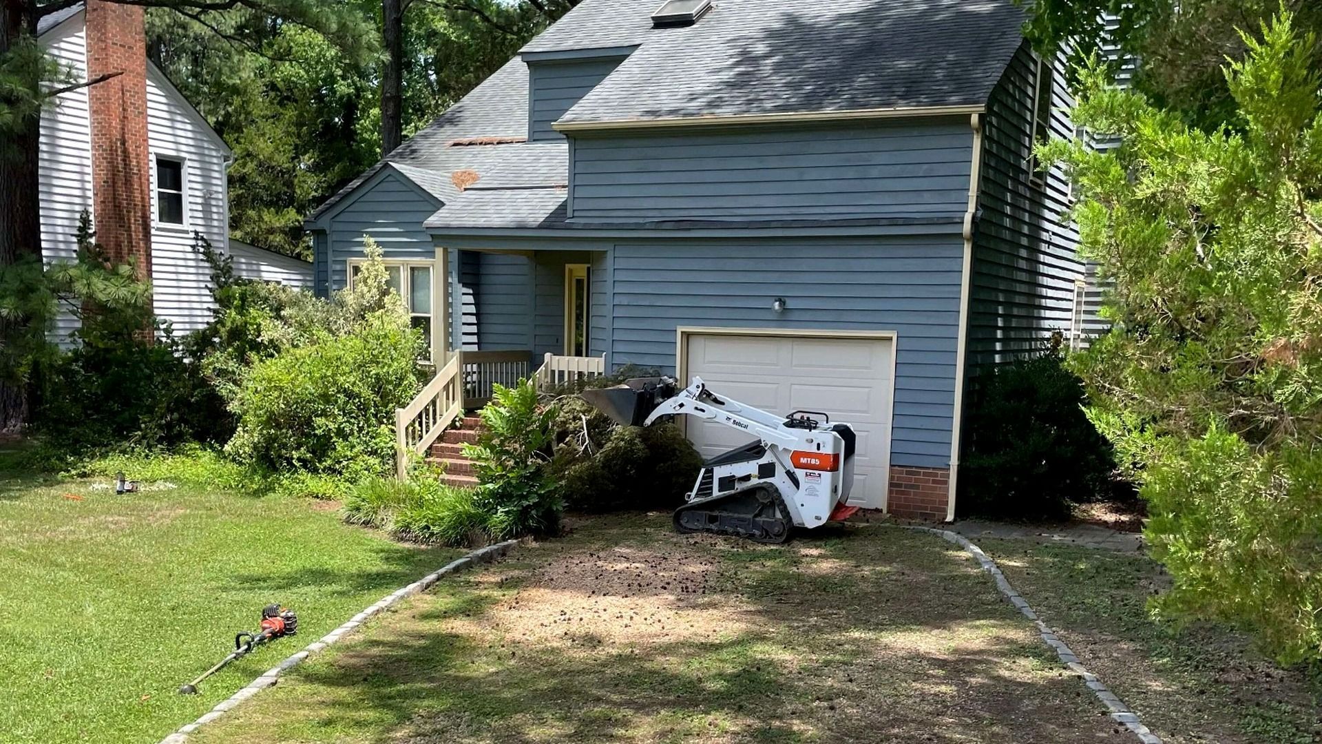 Existing gravel driveway before professional resurfacing and grading in Chesterfield, VA.