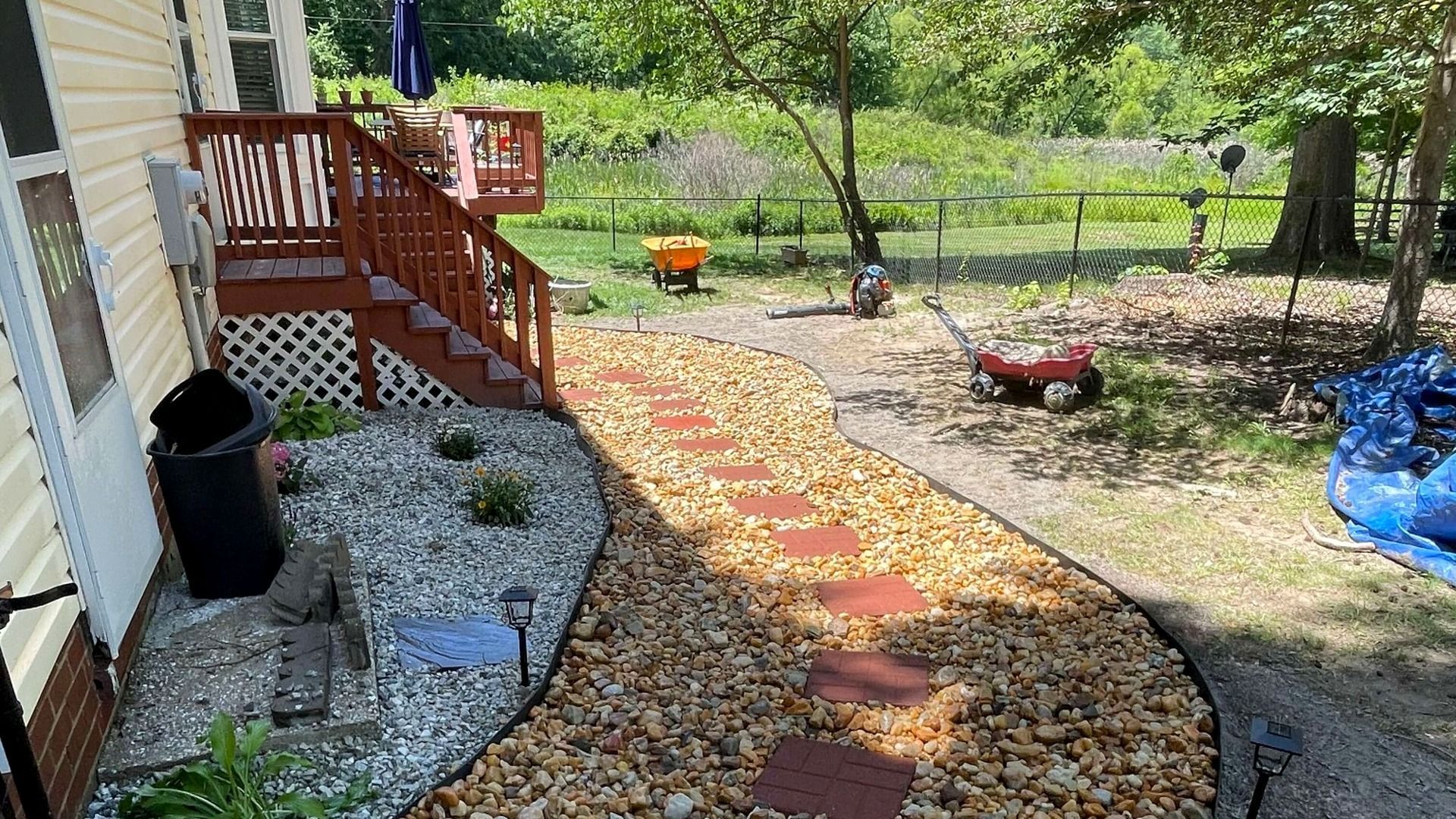 Complete landscape design services with river rock, paver patio walkways, shrubs, and more.