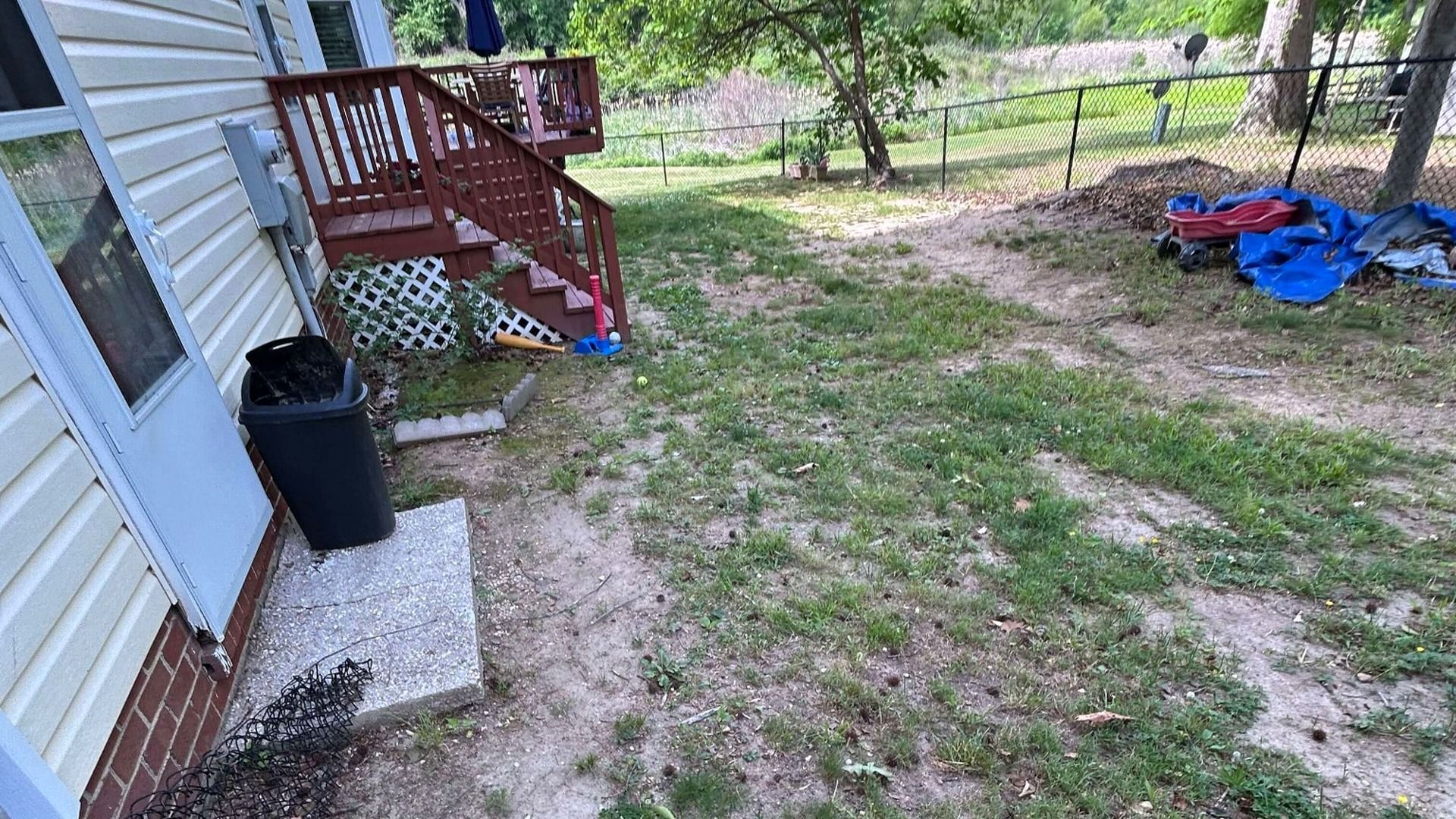 Backyard landscape before decorative river rock and stepping stone installation in Chesterfield, VA.