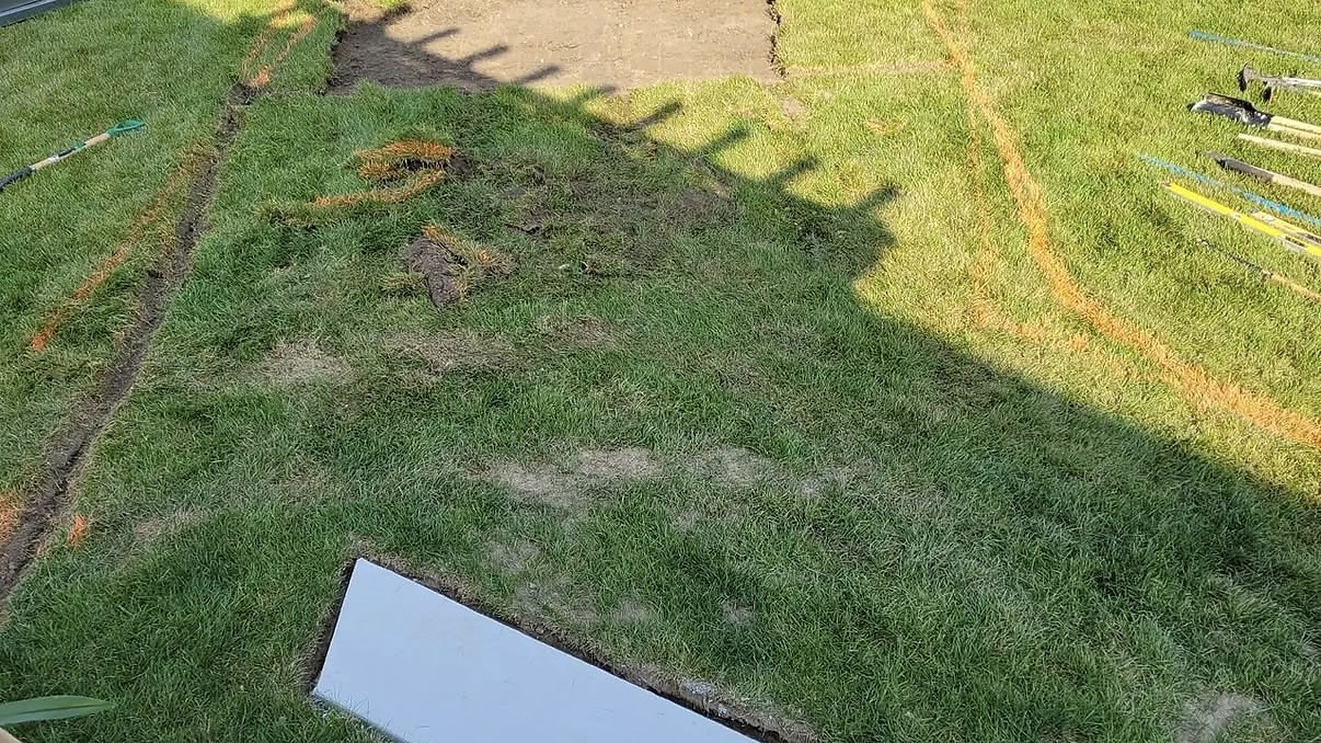 Paver patio site preparation by Tayeb's Landscaping showing excavation and base layout before patio installation in Chesterfield County, VA.