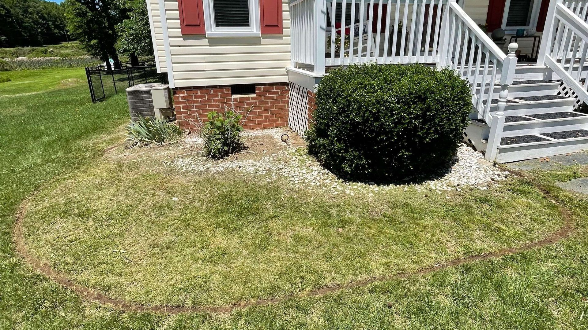Landscape bed prepared for decorative river rock installation by Tayeb's Landscaping in Chesterfield, VA.