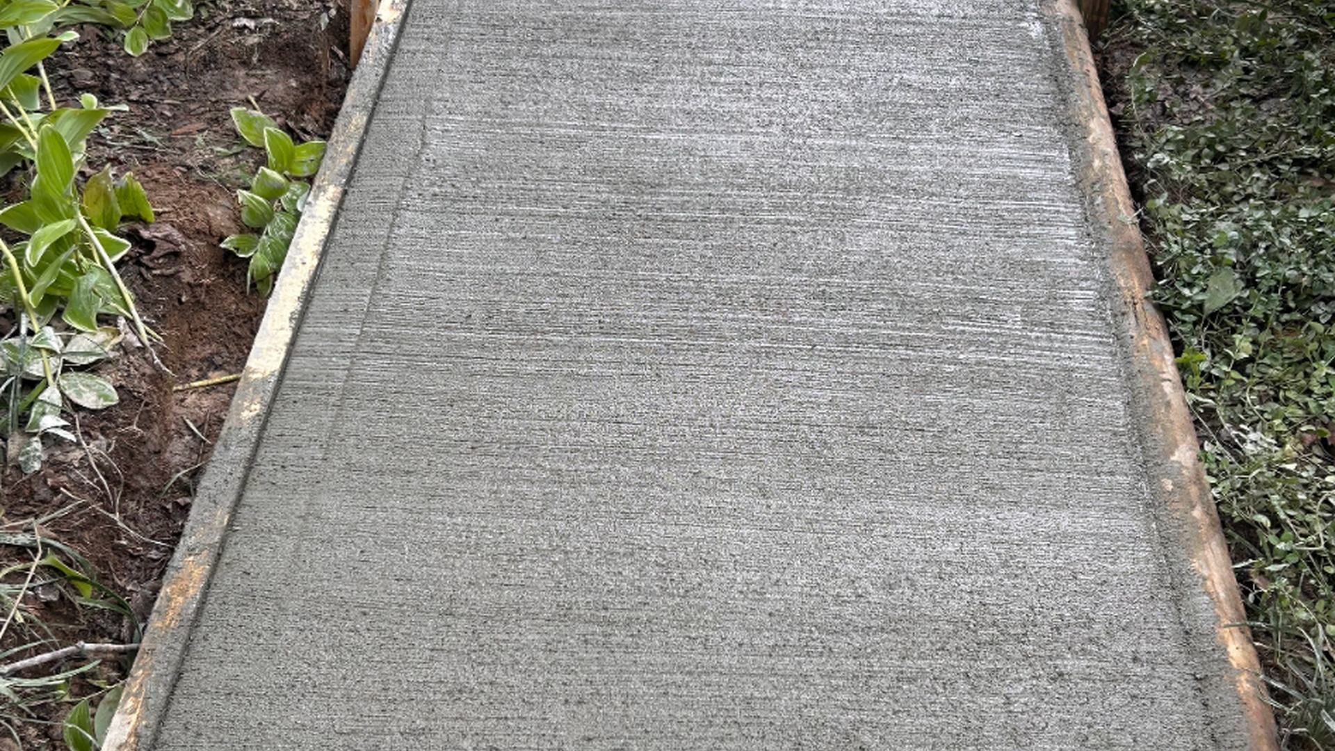 Concrete walkway installation in progress for a residential property in Chesterfield County, VA