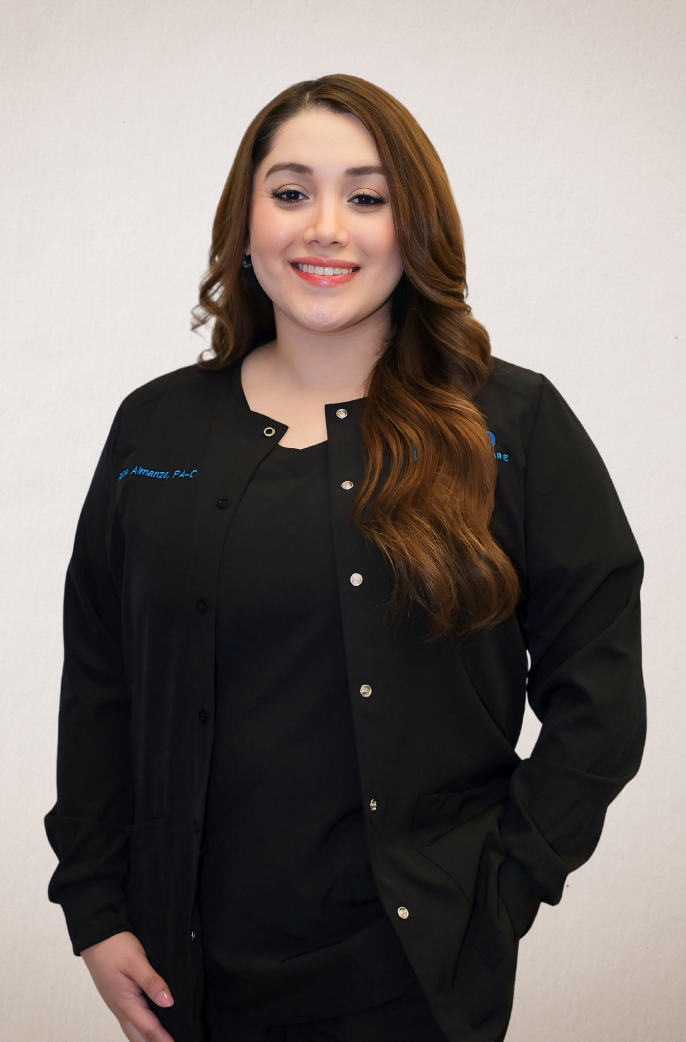 The woman is wearing a black jacket and smiling for the camera.