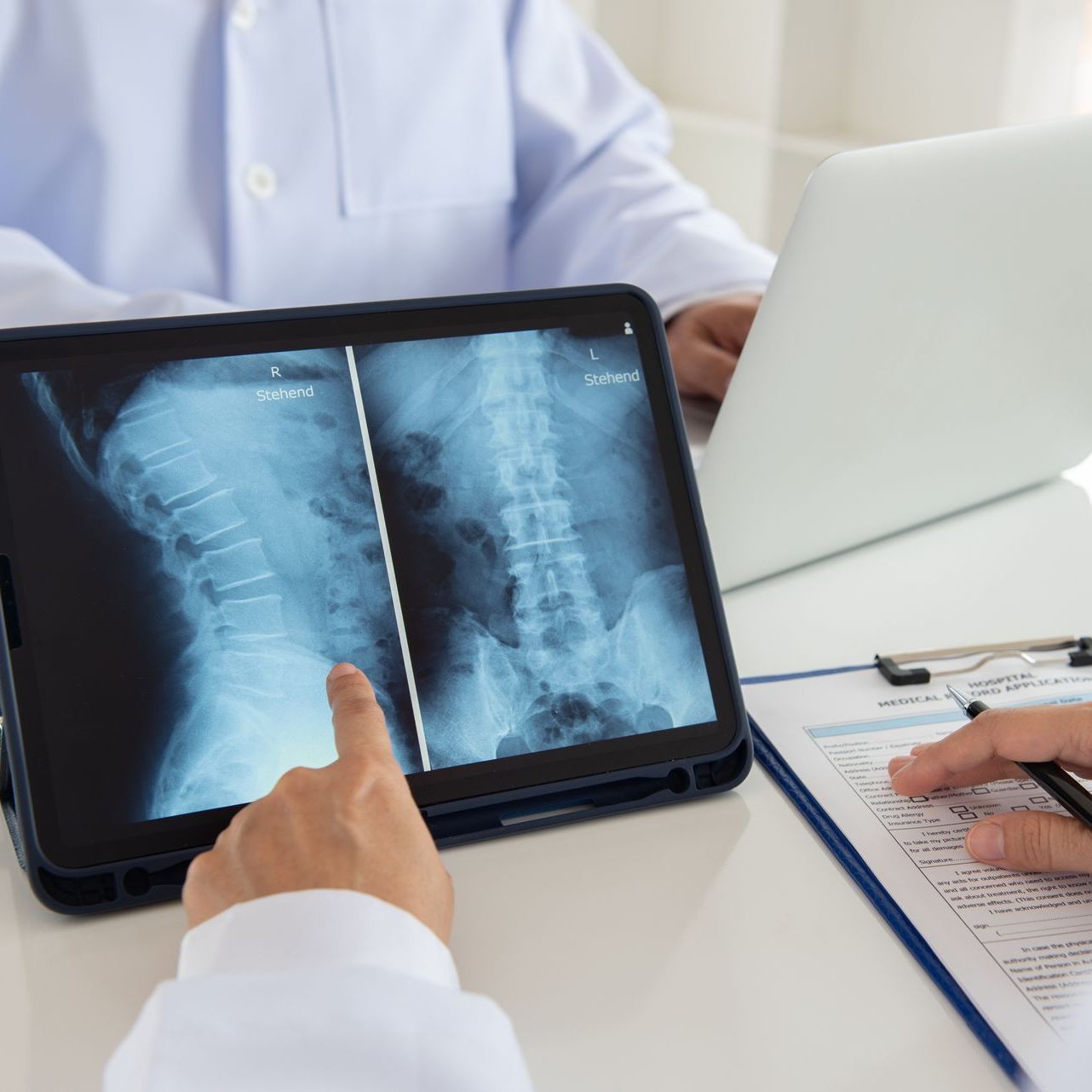 doctor diagnose spine lumber vertebrae x-ray image on digital tablet for diagnose