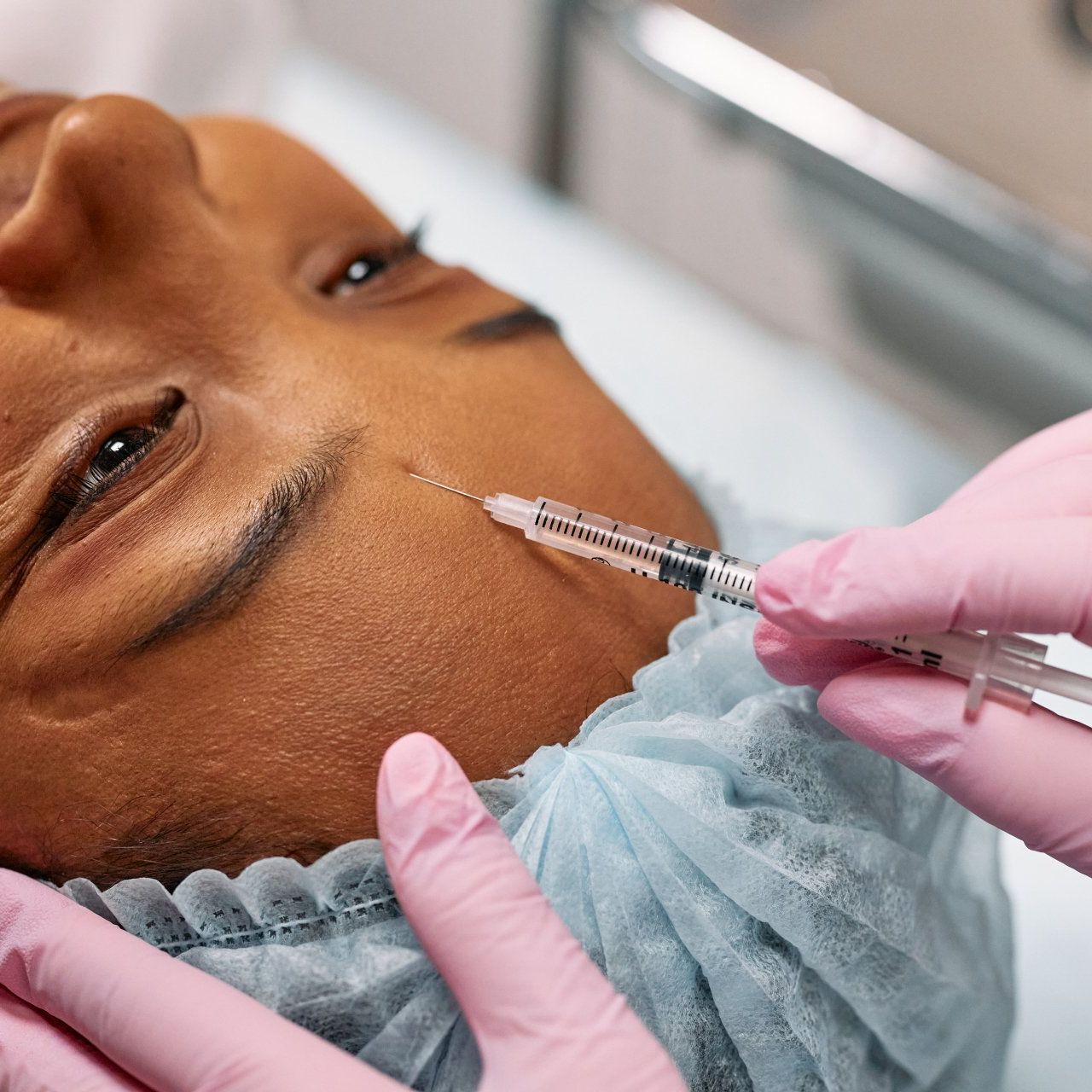 Doctor doing stem cell therapy on a patient's knee after the injury. Treating knee pain with platelet-rich plasma injection.