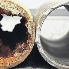 Cutaway view of two pipes; one heavily corroded, the other clean and smooth.