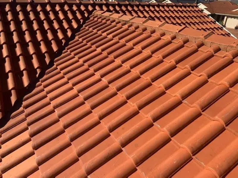 A Close Up of a Roof With Red Tiles on It — Norwest Roof Restorations In Central Coast, NSW