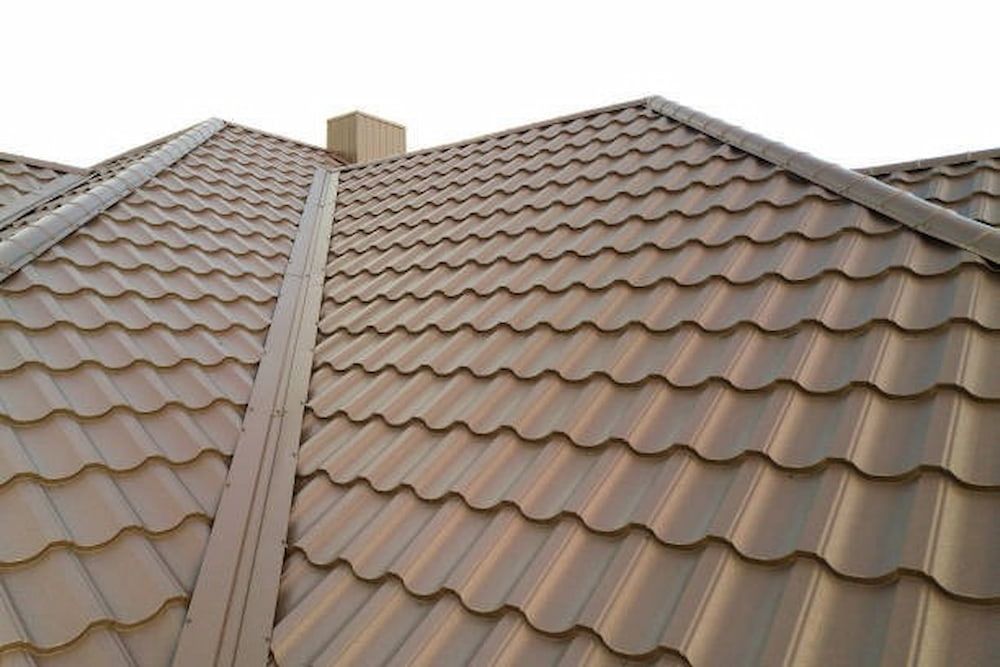 A Metal Roof With Overlapping Brown Tiles Forms a Neat