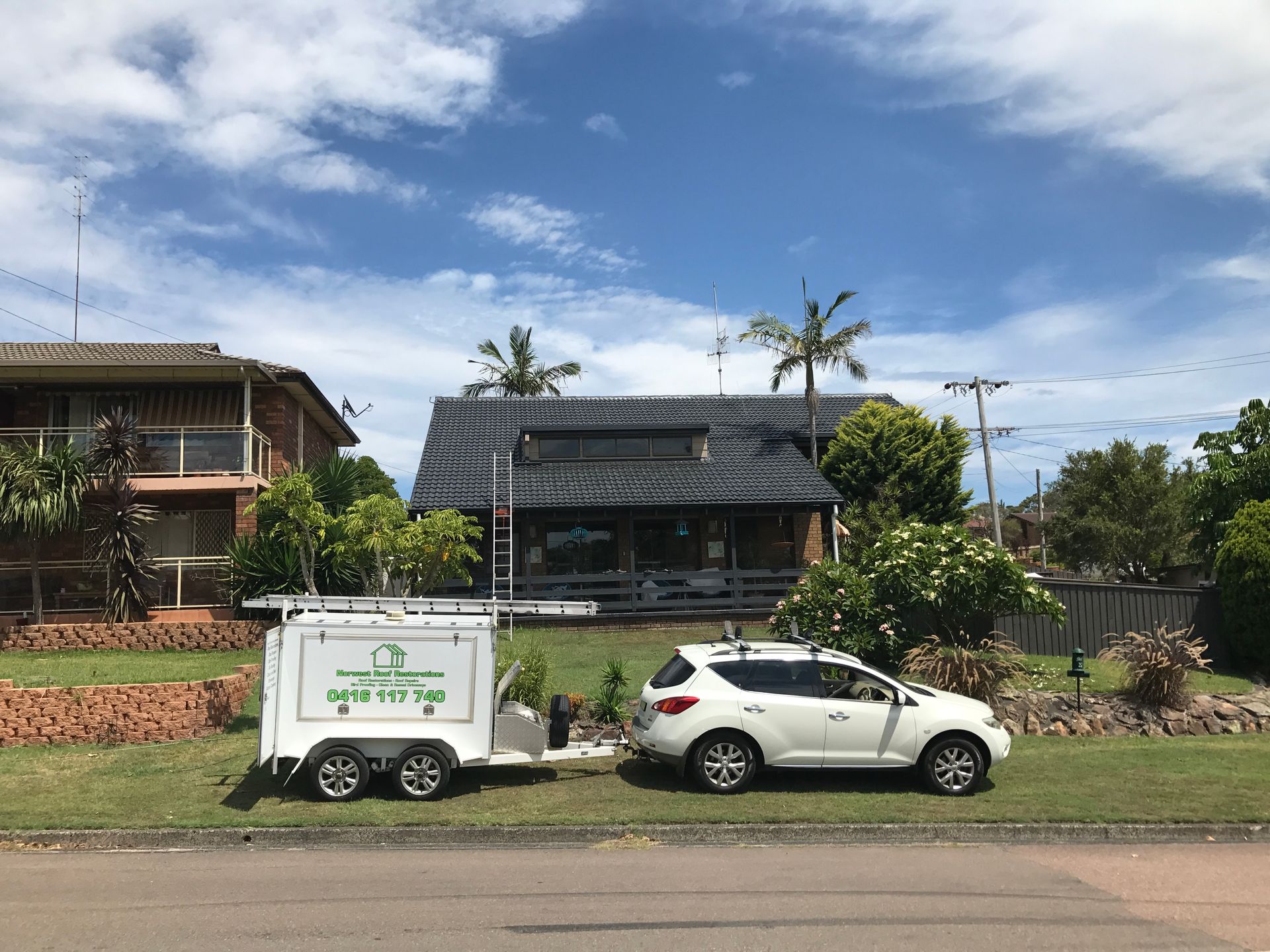 Workers Repairing a White House Roof — Norwest Roof Restorations In Blue Bay, NSW
