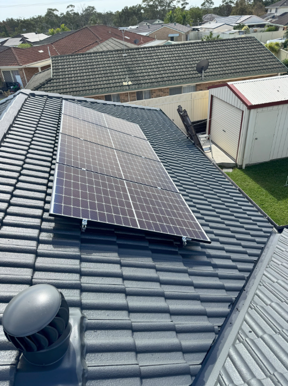 A Row of Solar Panels on a Roof — Norwest Roof Restorations In Central Coast, NSW