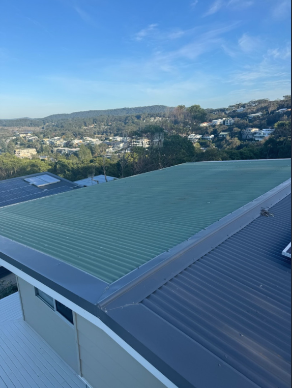A Close Up of a Brown Gutter on the Side of a Building — Norwest Roof Restorations In Central Coast, NSW