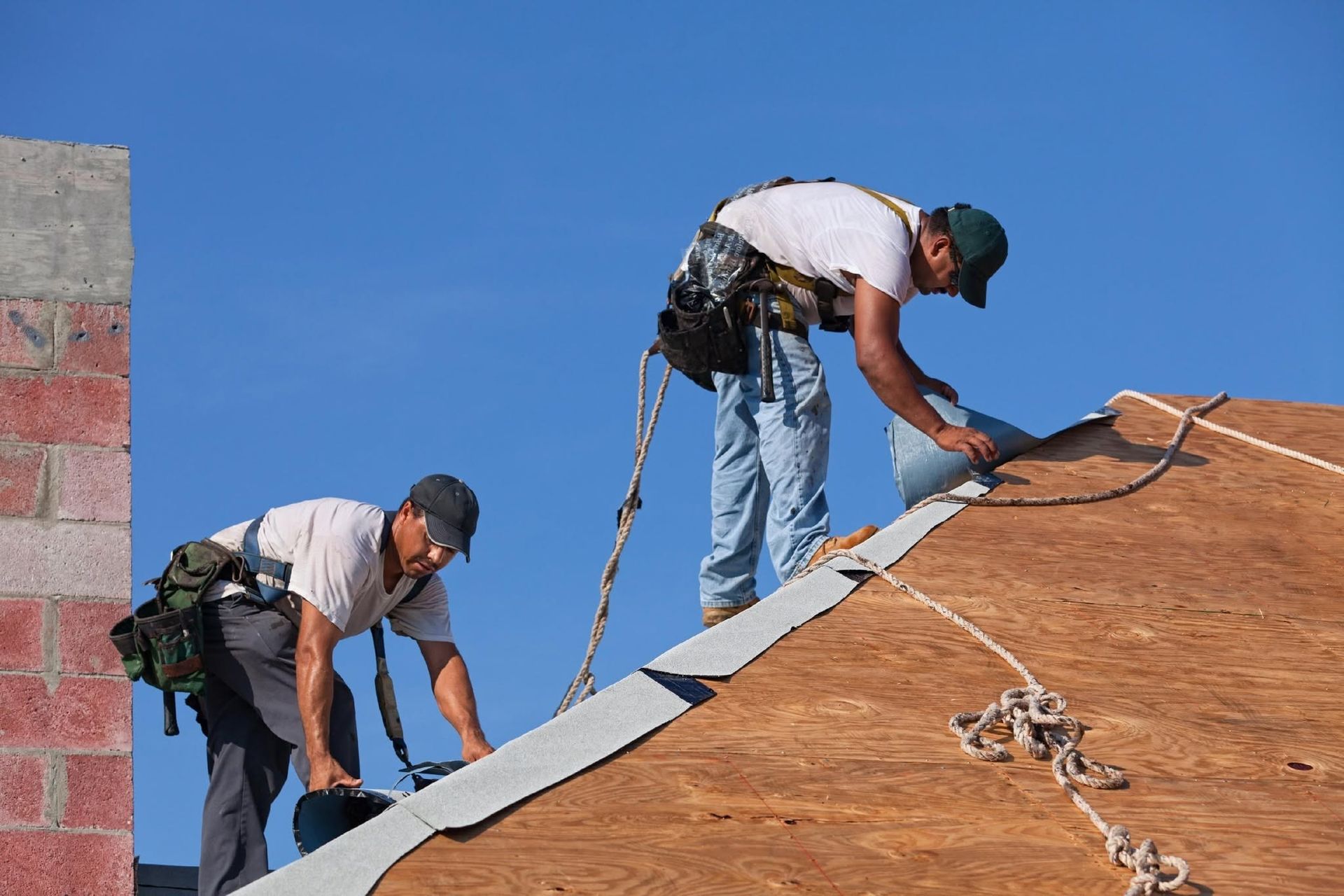 Two Roofers Are Working on Roof in Gosford
