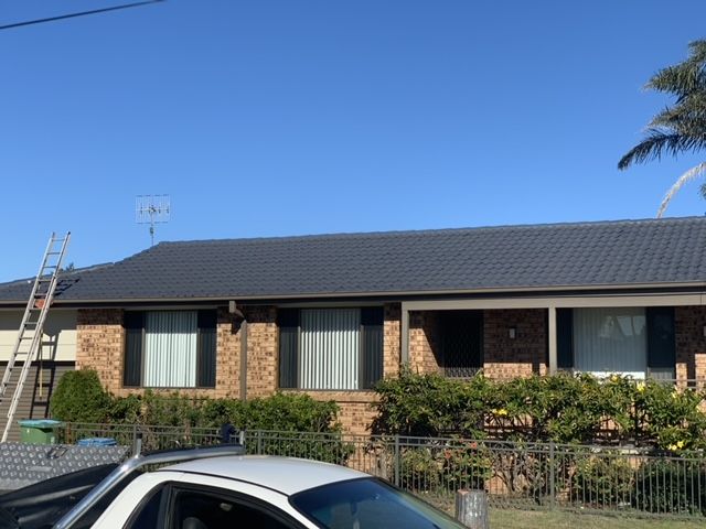 A Close Up of a Brown Gutter on the Side of a Building — Norwest Roof Restorations In Blue Bay, NSW