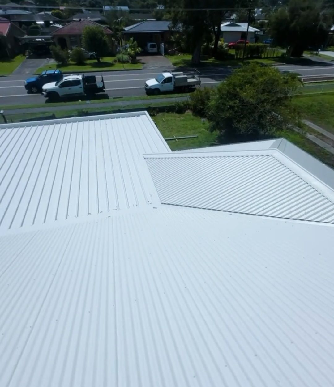 White Metal Roof Overlooking a Suburban Street — Norwest Roof Restorations In Newcastle, NSW