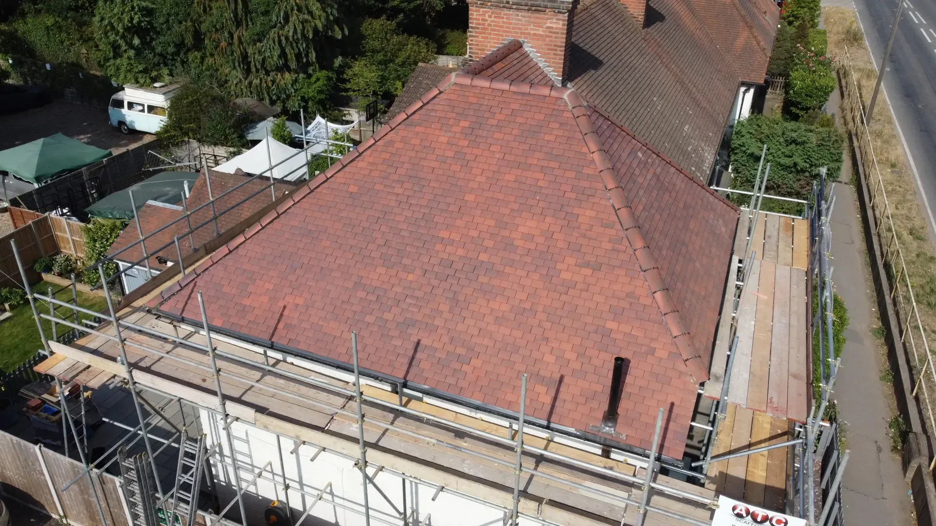An aerial view of a house with scaffolding on the roof.