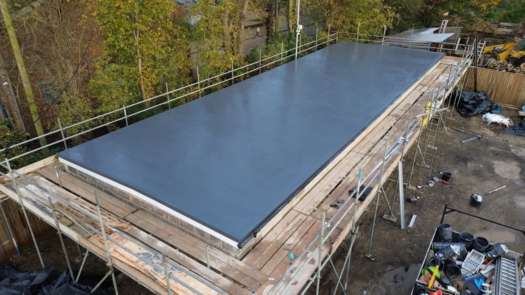 A large roof is being built on top of a wooden scaffolding.