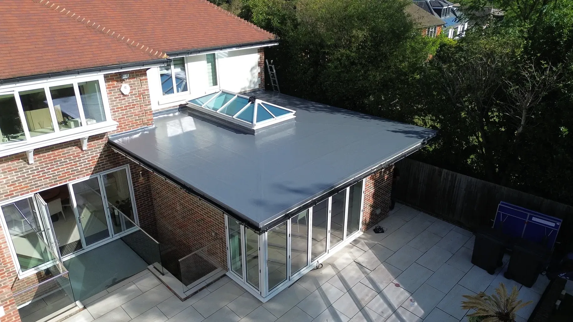 An aerial view of a house with a roof extension.