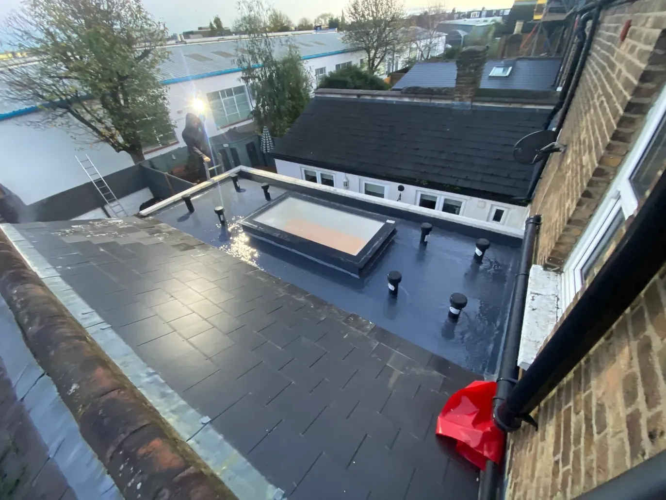 An aerial view of a roof with a skylight on it.