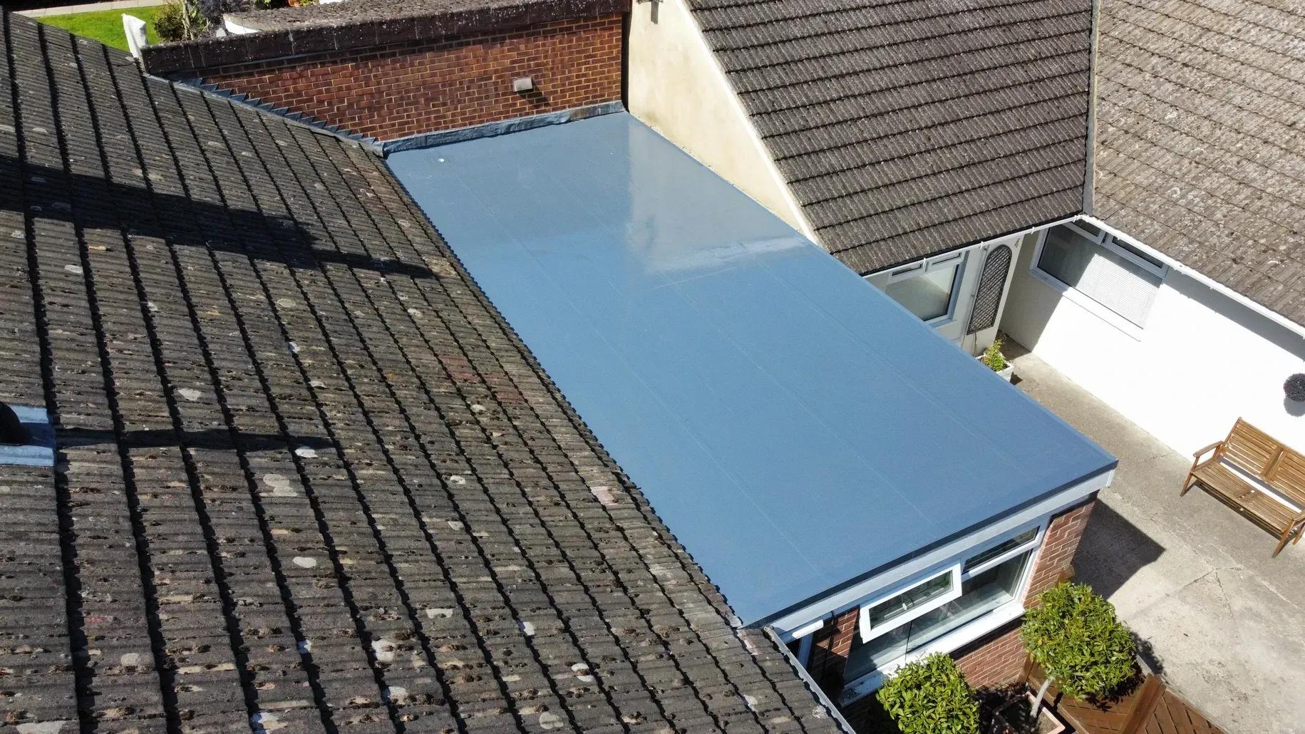 An aerial view of a roof with a blue roof