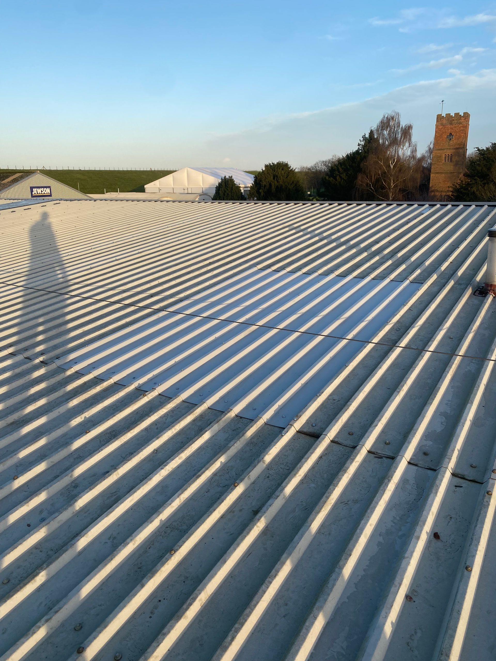 a shadow of a person is cast on the roof of a building