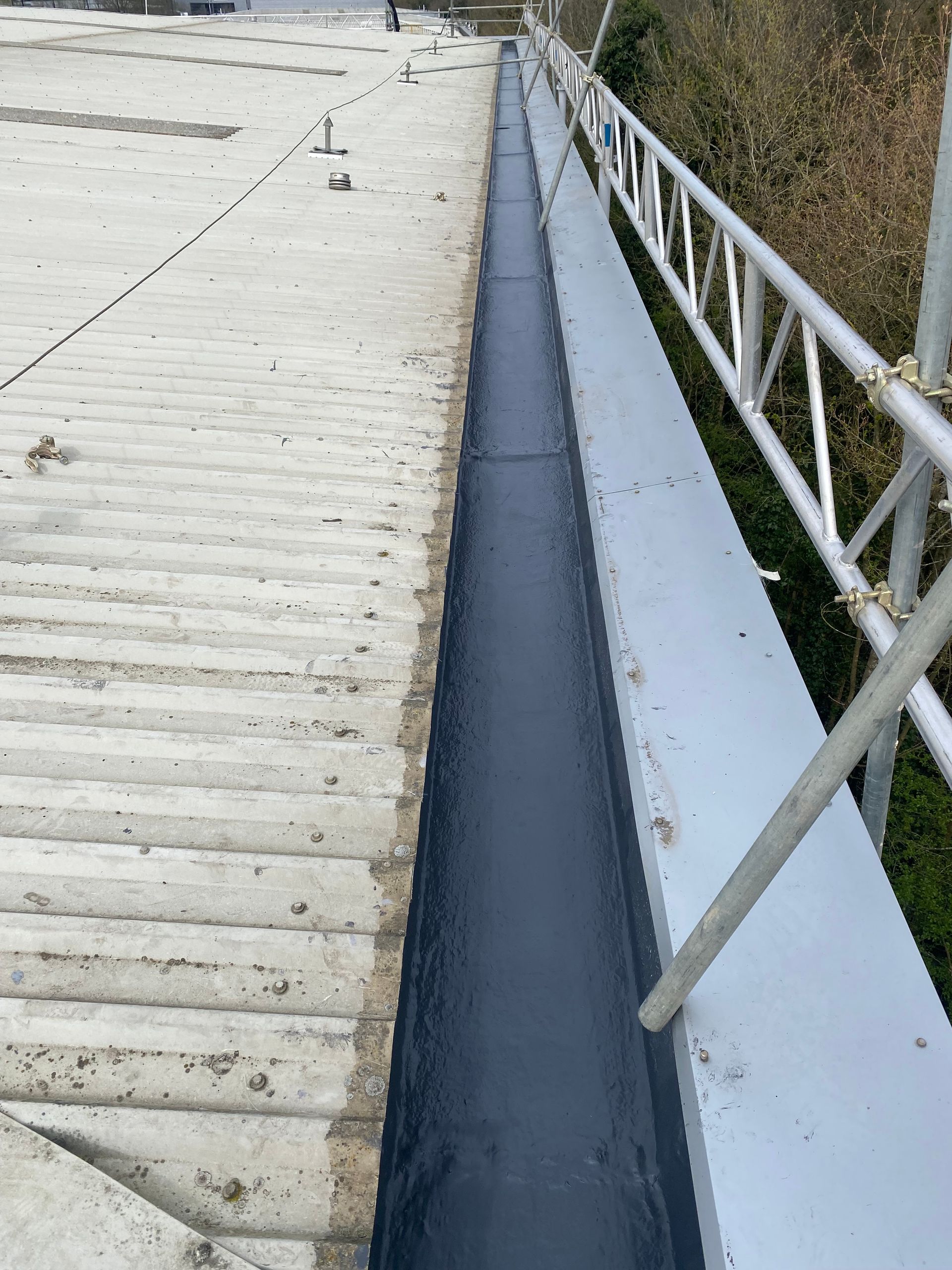 a gutter is being installed on the side of a building .