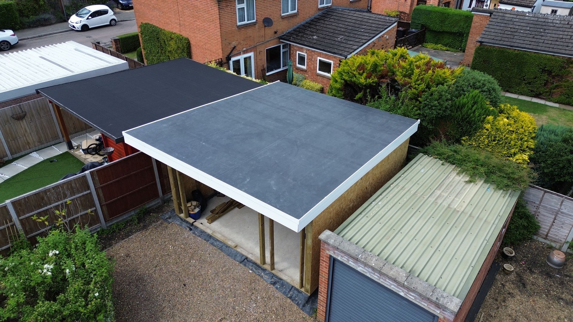an aerial view of a garage with a roof and a shed .