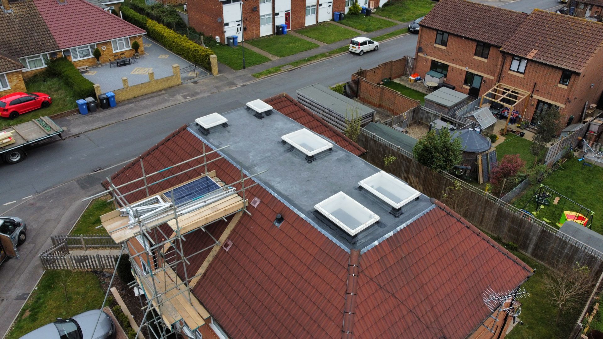 an aerial view of a house with a flat roof in a residential area .