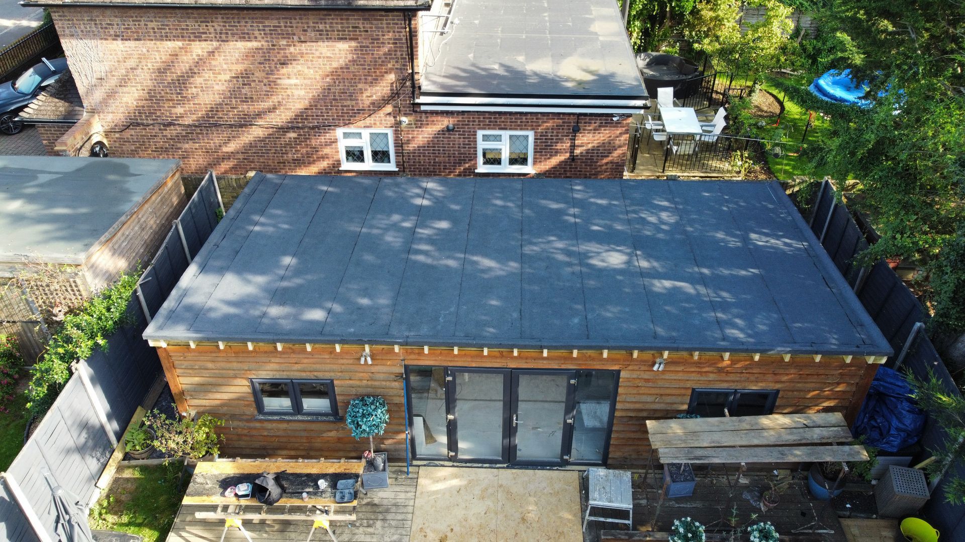 an aerial view of a house with a roof that is covered in felt roofing
