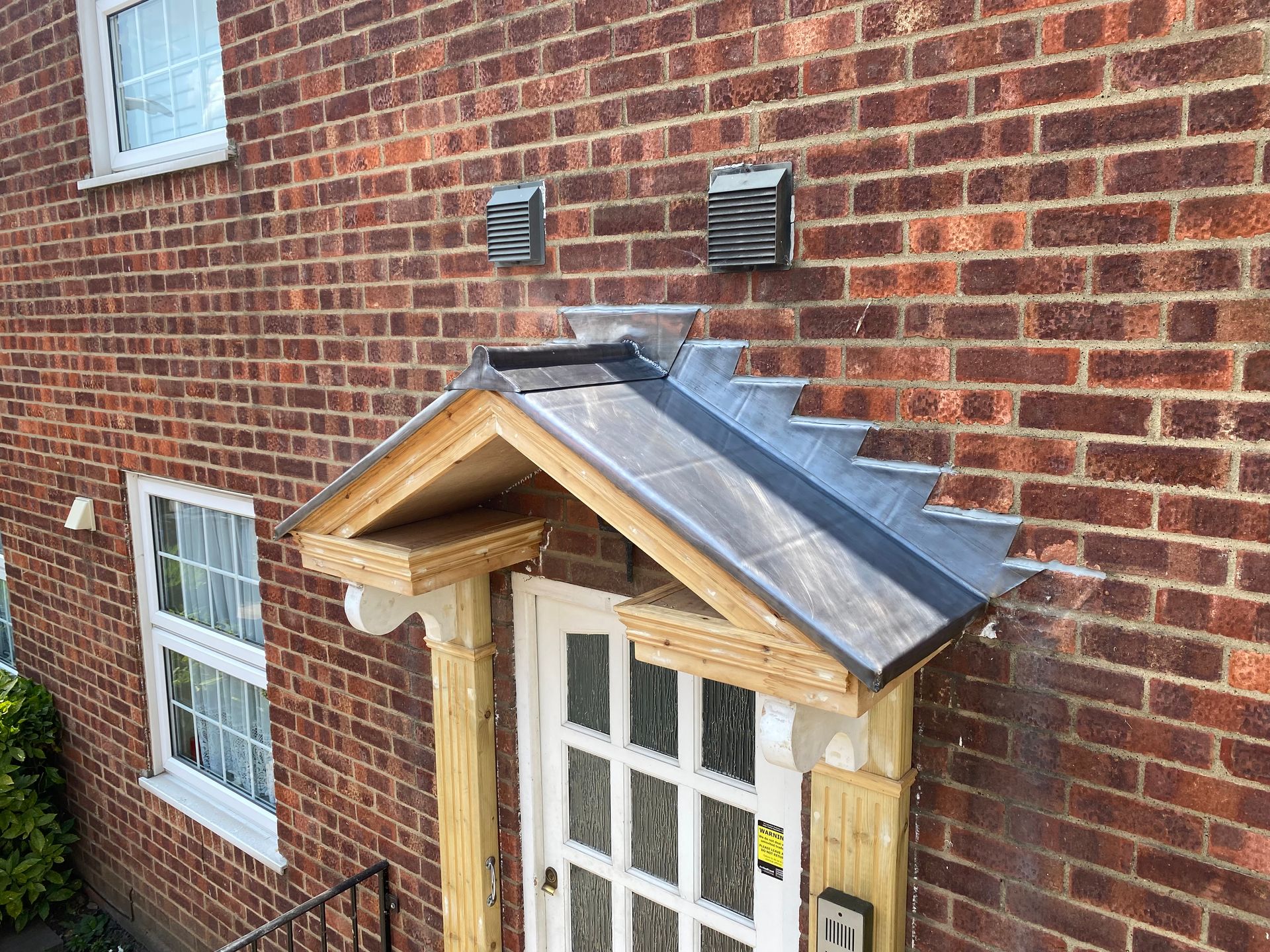 a brick building with a wooden porch over a door .