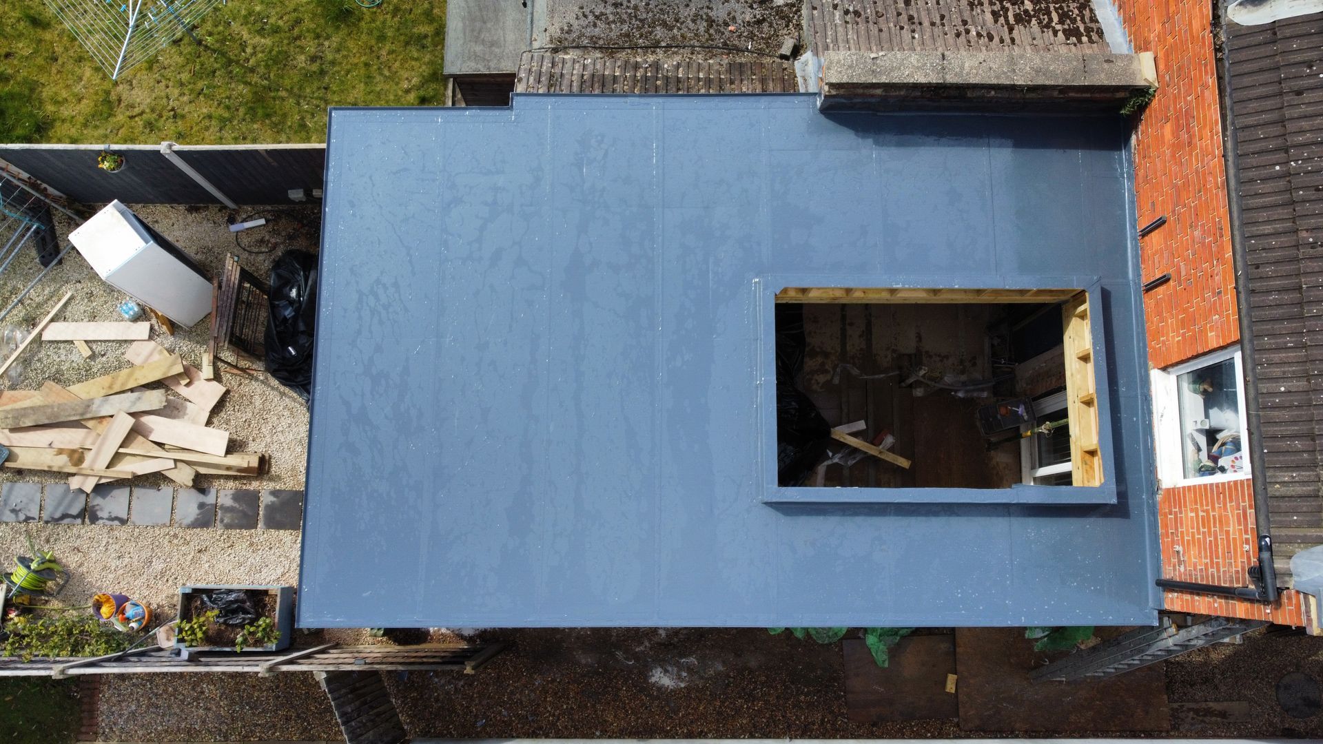 an aerial view of a building under construction with a window in the roof .