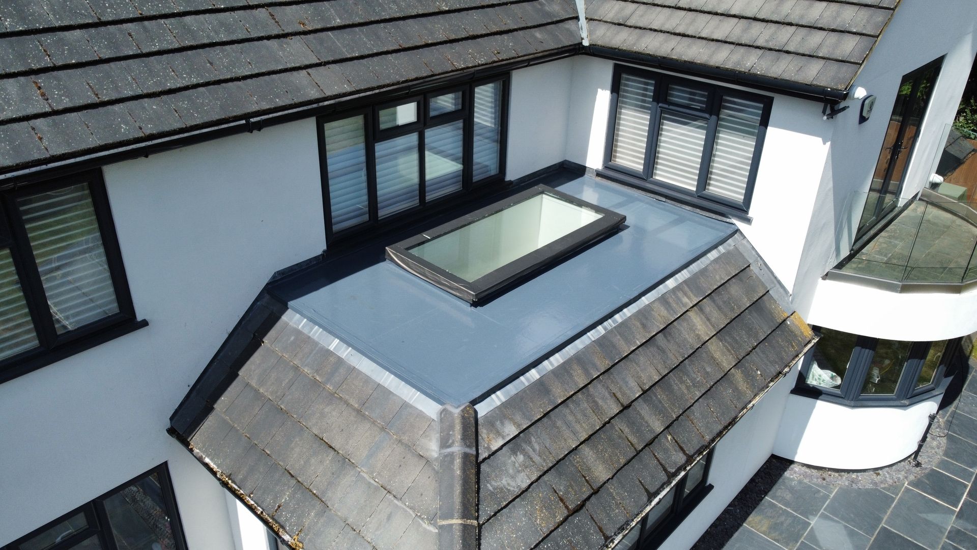 an aerial view of a house with a skylight on the roof .