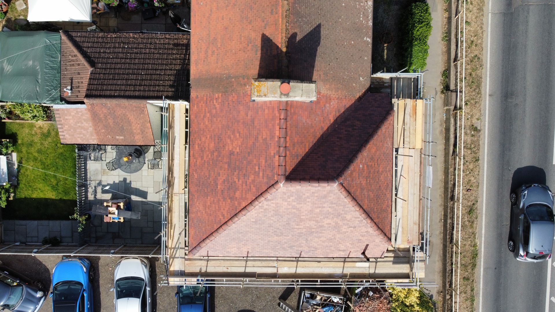 an aerial view of a house under construction with a red tiled roof .