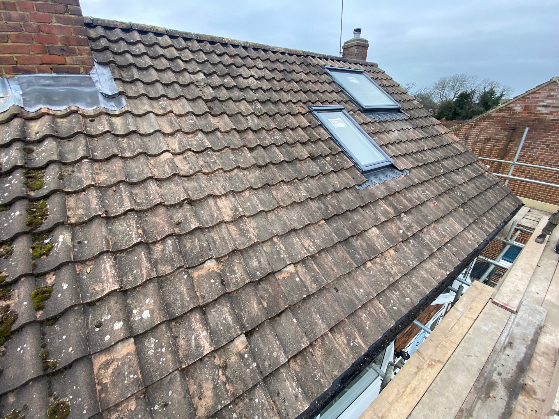 there are two skylights on the roof of a house .