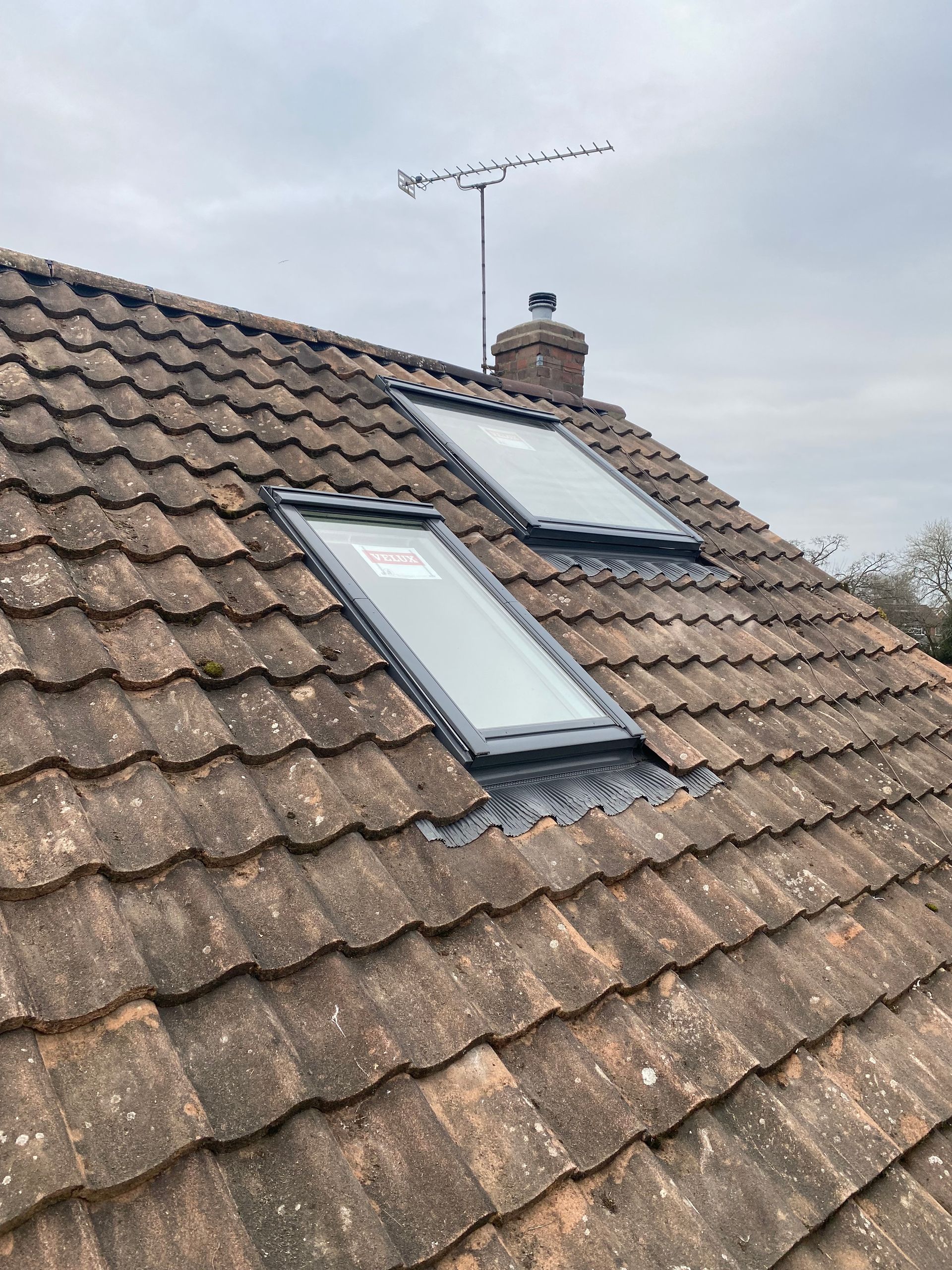 there are two skylights on the roof of a house .