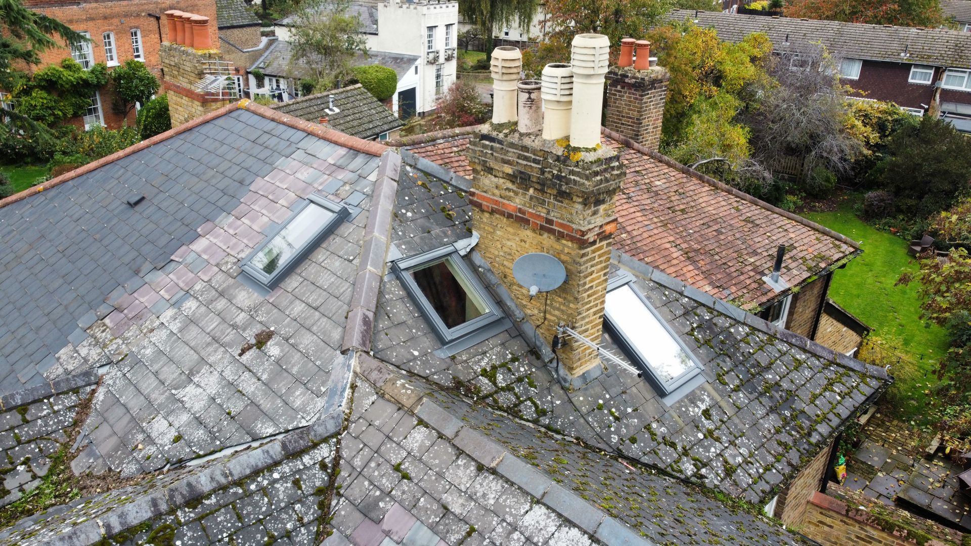 an aerial view of a roof with skylights and chimneys .
