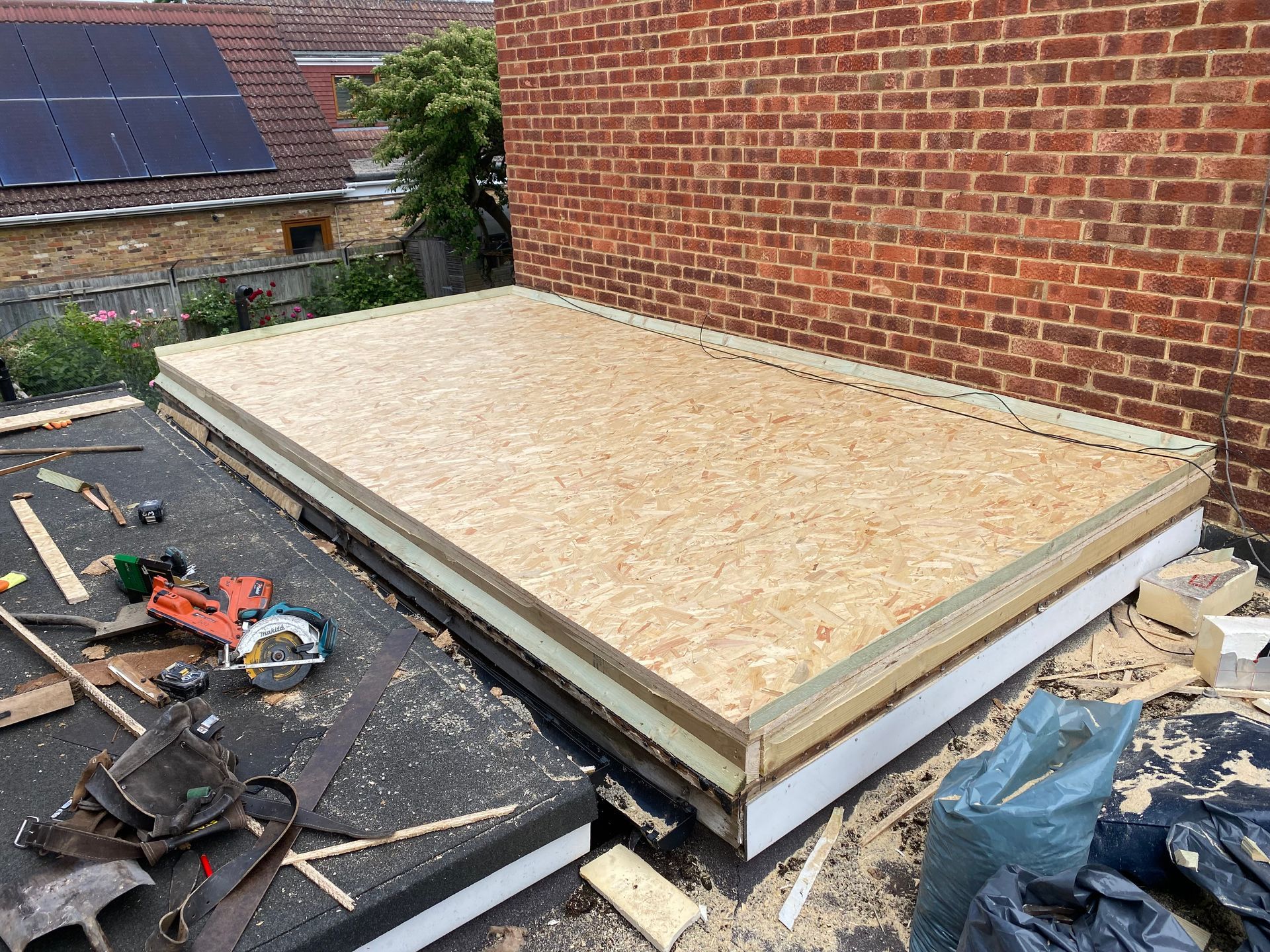 a large flat roof next to a brick wall .