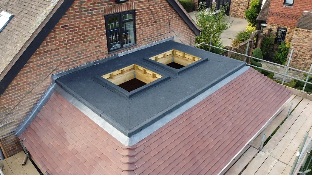 small flat roof with holes for roof light installation
