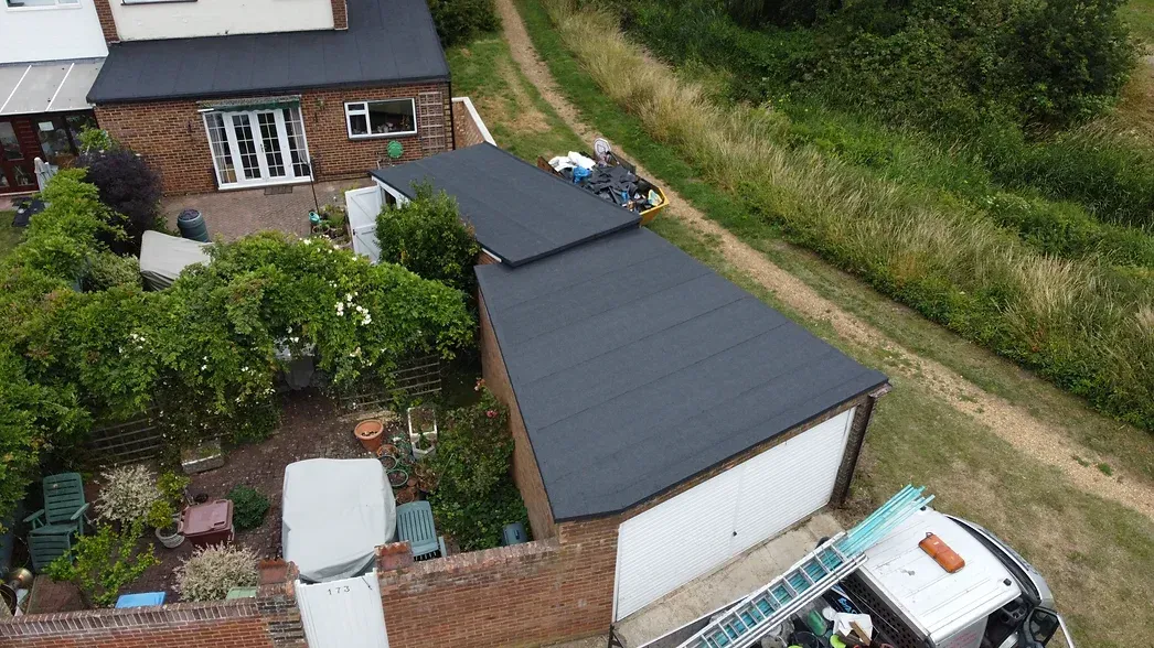 garage with flat felt roof