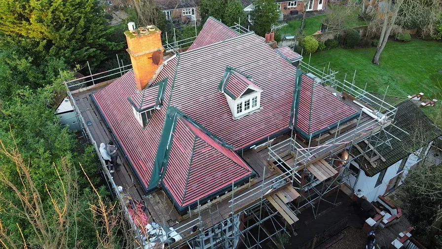 large country house surrounded by roofer scaffolding