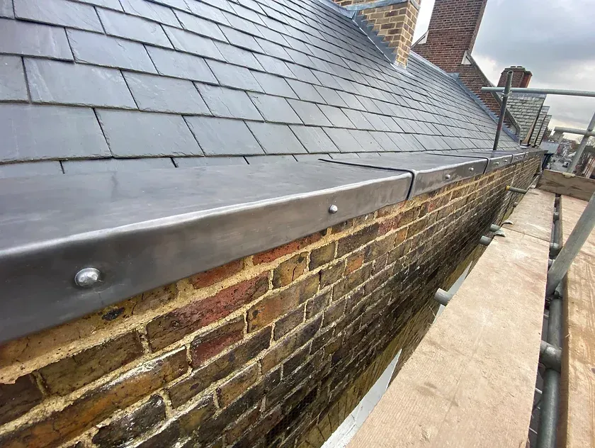 leadwork flashing along roof gutter