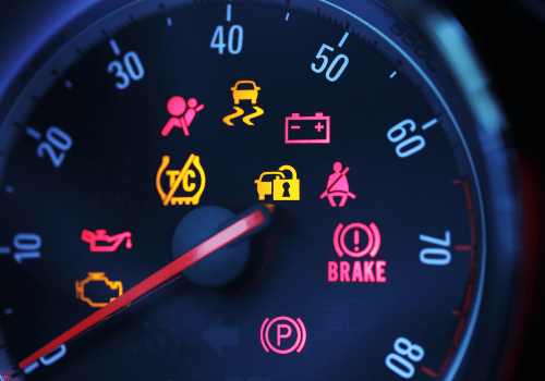 Vehicle dashboard with illuminated warning lights for brakes, battery, engine, and oil.