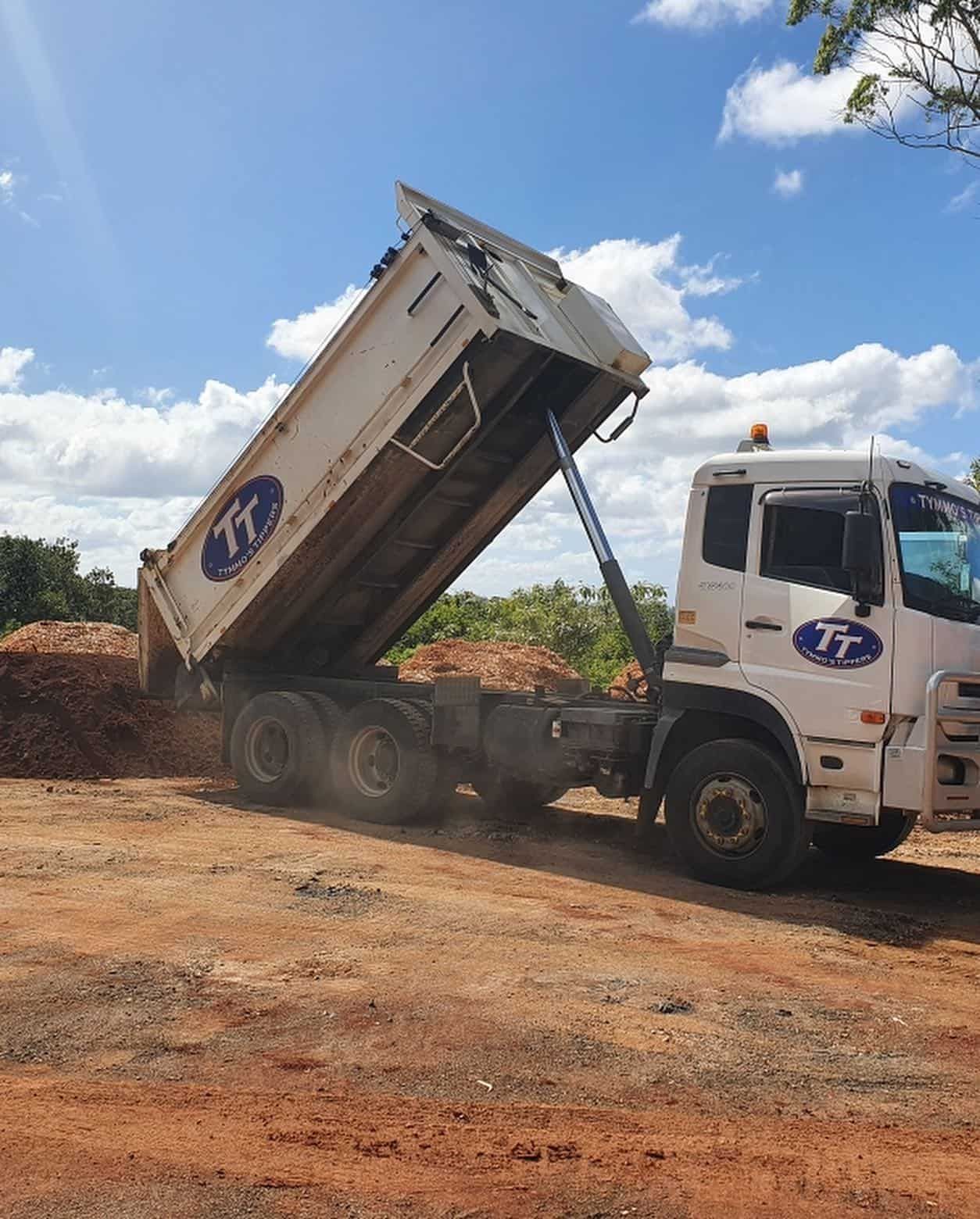 A Dump Truck Is Parked In A Dirt Lot With Its Bed Open — Tymmo's Tippers In West Ballina, NSW
