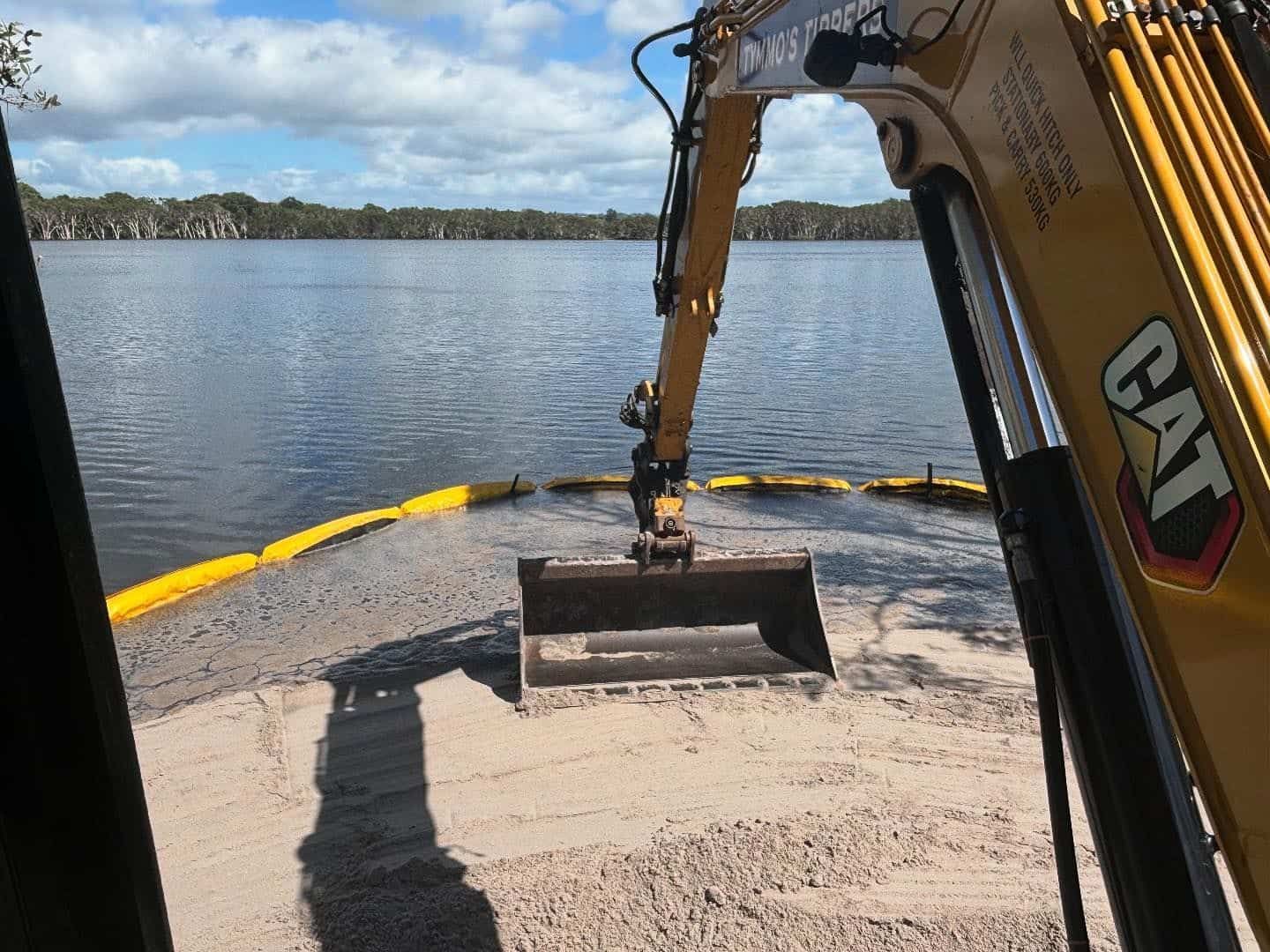 A Cat Excavator Is Working On A Beach Near A Lake — Tymmo's Tippers In Tweed Heads, NSW