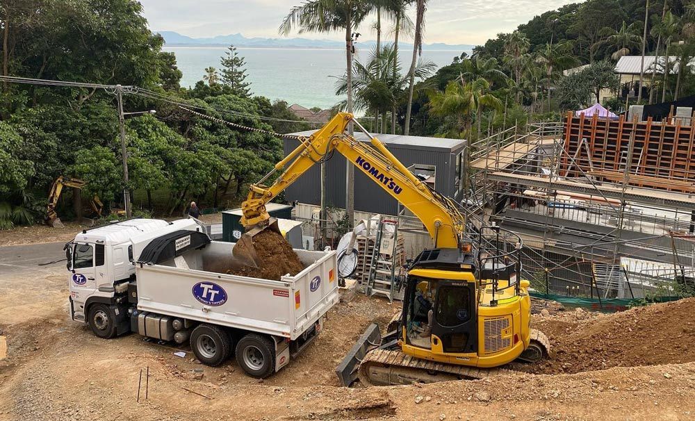 A Yellow Excavator At Work In Lismore