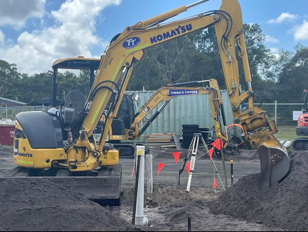 Two Komatsu Excavators Are Working On A Construction Site — Tymmo's Tippers In Lennox Head, NSW