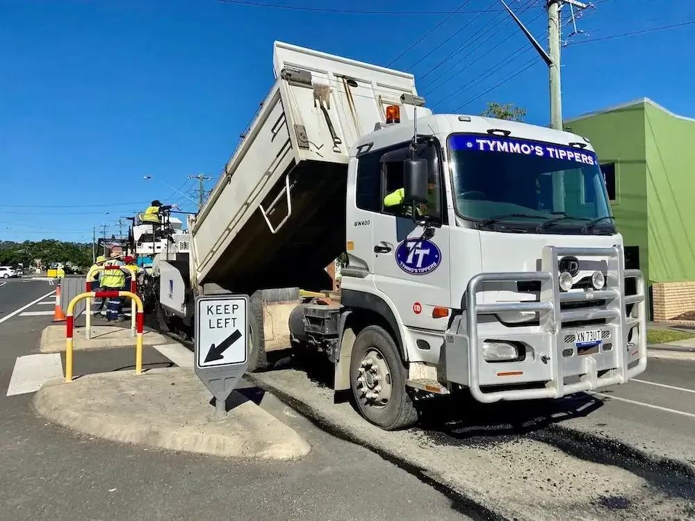 A Dump Truck Is Parked On The Side Of The Road Next To A Keep Left Sign — Tymmo's Tippers In Lennox Head, NSW