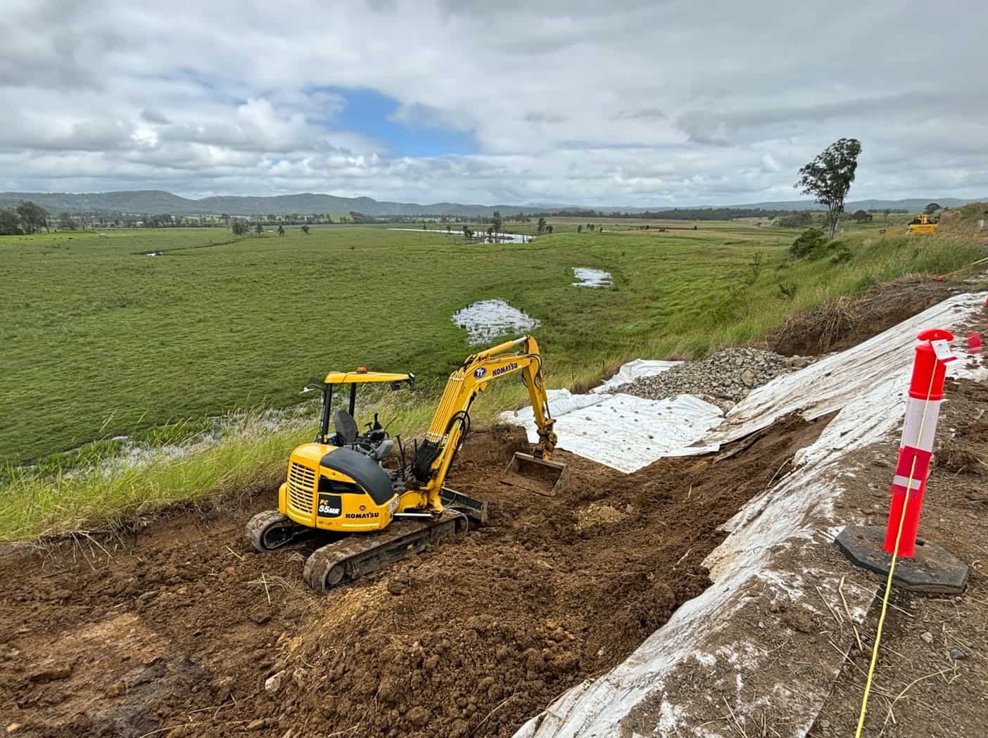 A Cat Excavator Is Working On A Landslip By A Field — Tymmo's Tippers In West Ballina, NSW