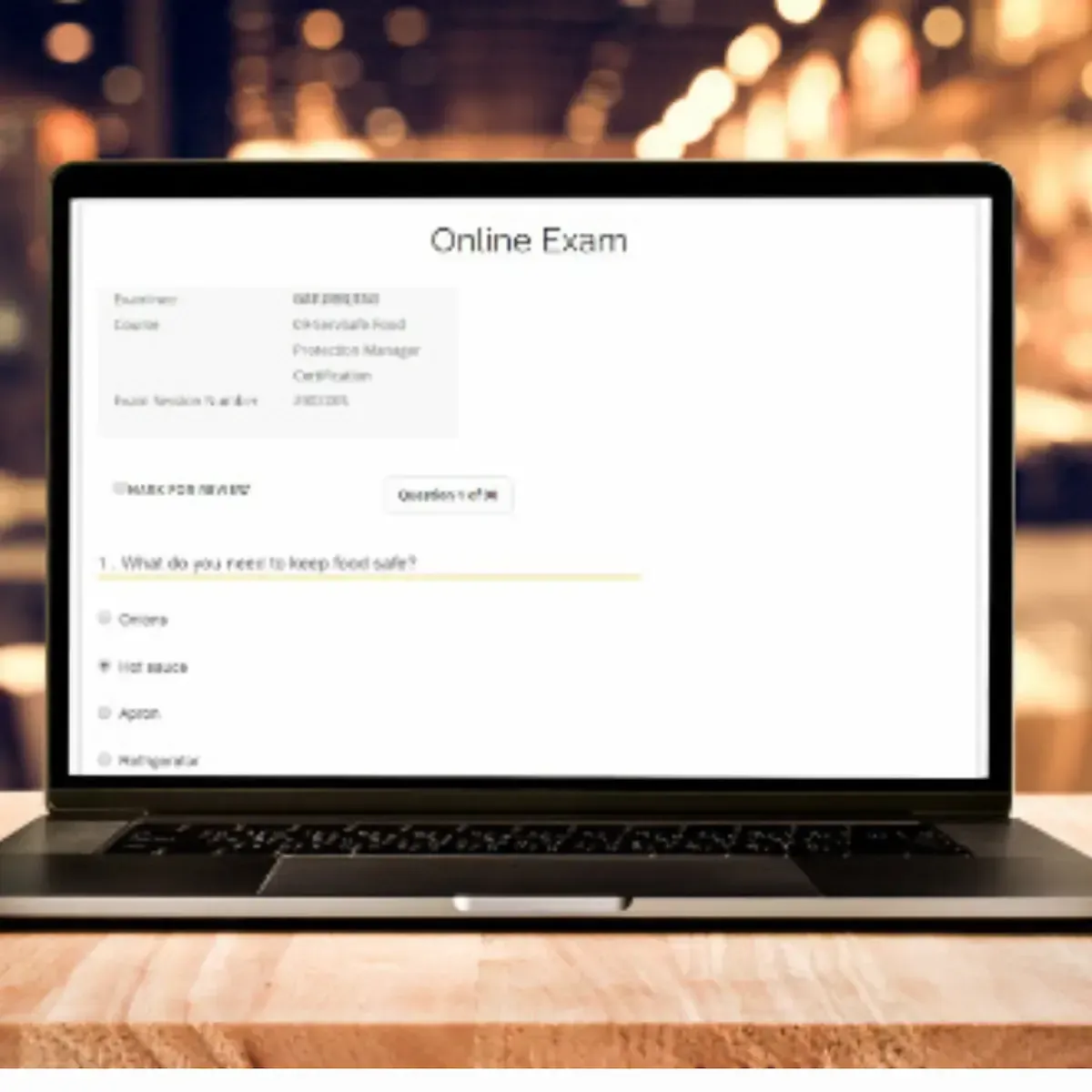 ServSafe Manager Exam Code showing an open laptop.
