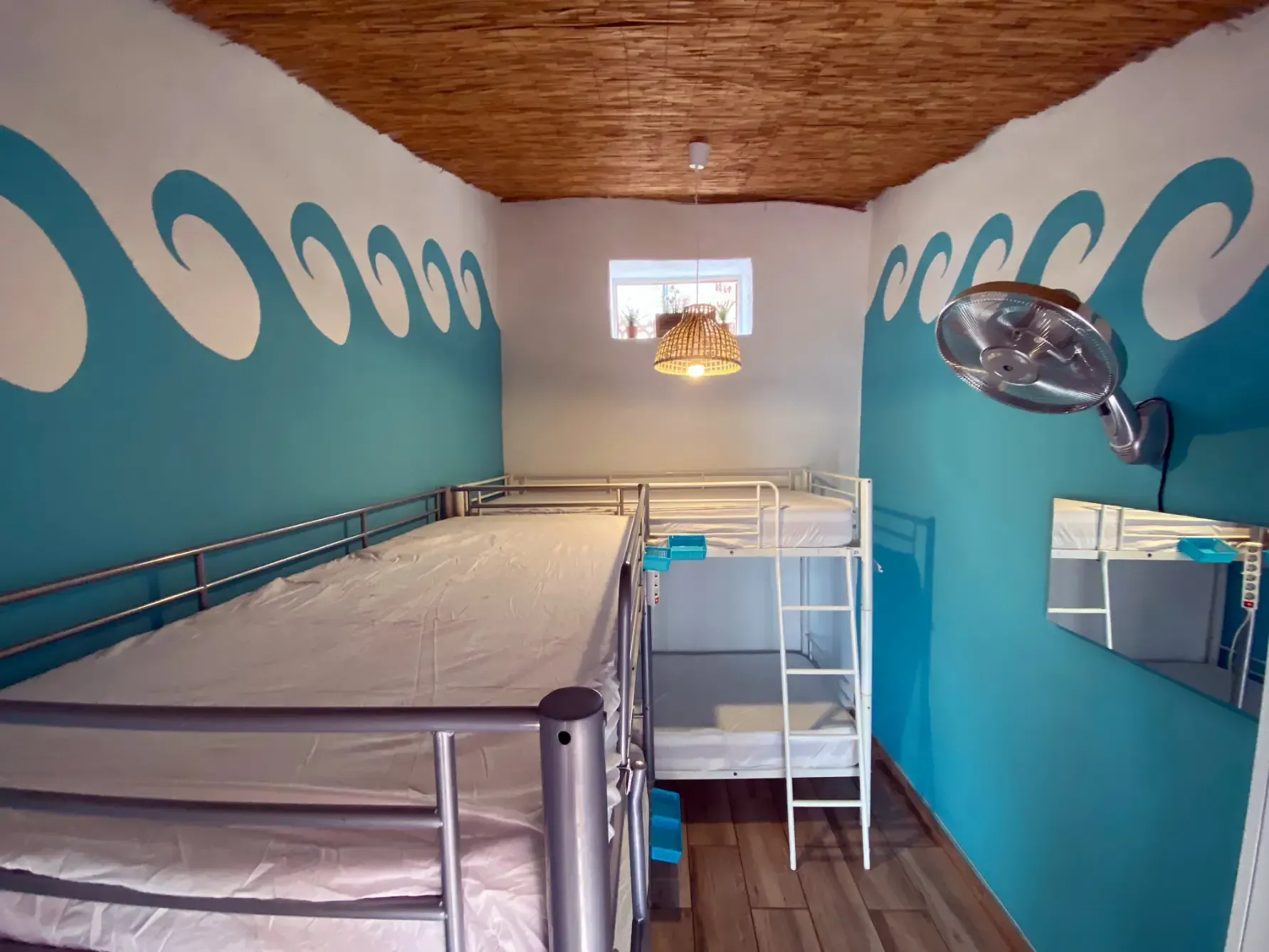 a room with bunk beds and a mirror on the wall