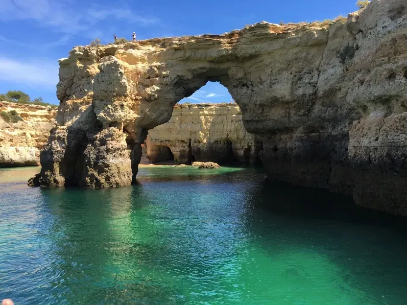 a large rock arch over a body of water